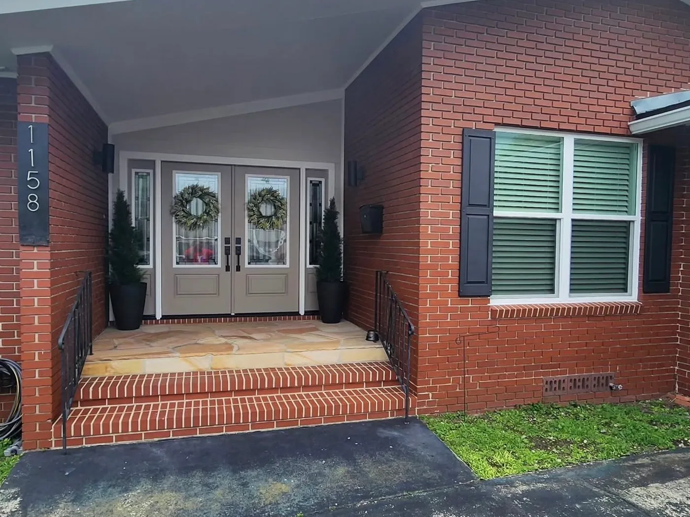 Open double-door front entry on a brick home before screening, Northeast Florida
