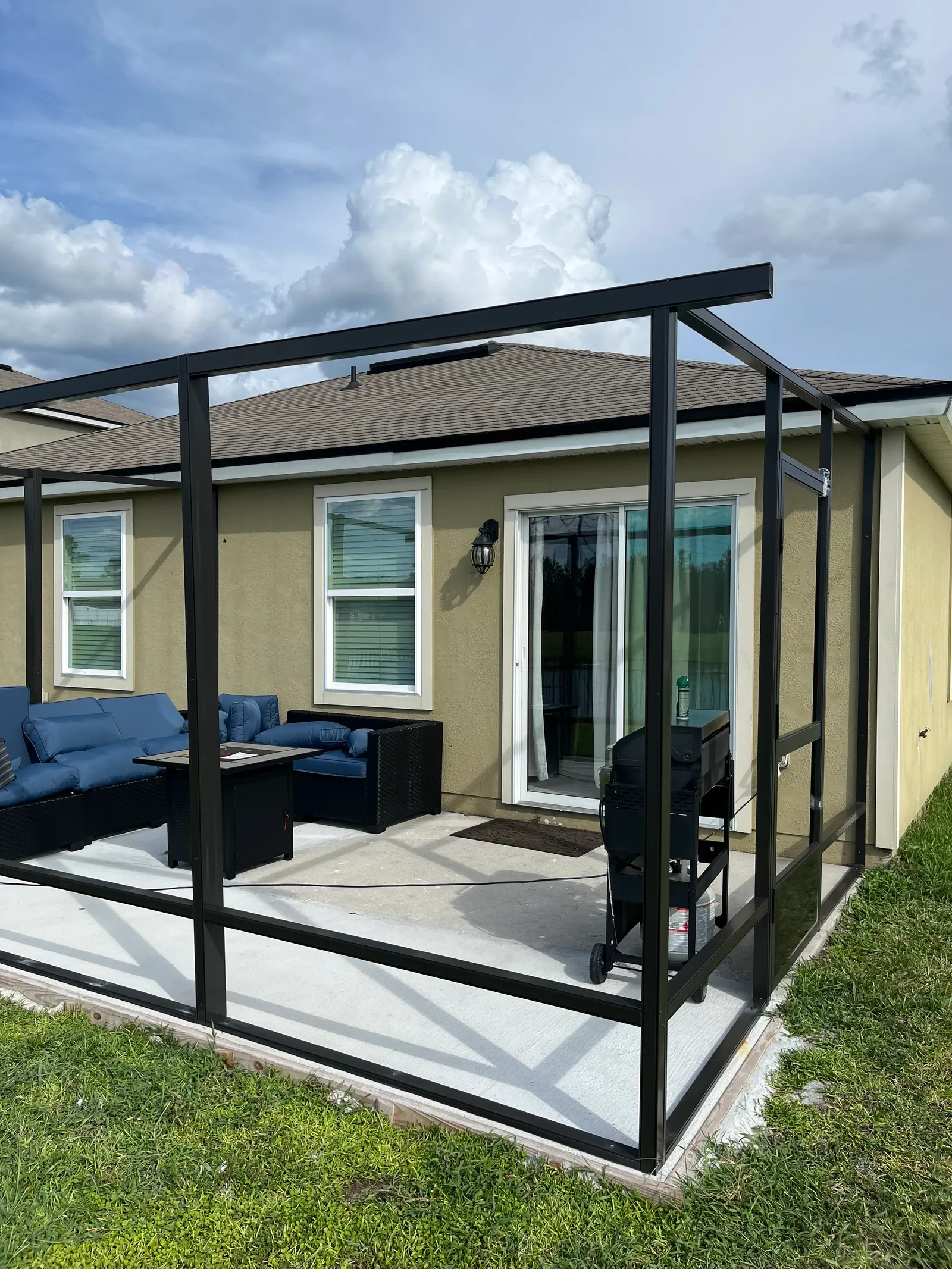 Aluminum screen enclosure frame going up on a Jacksonville, FL home — permitted structural work