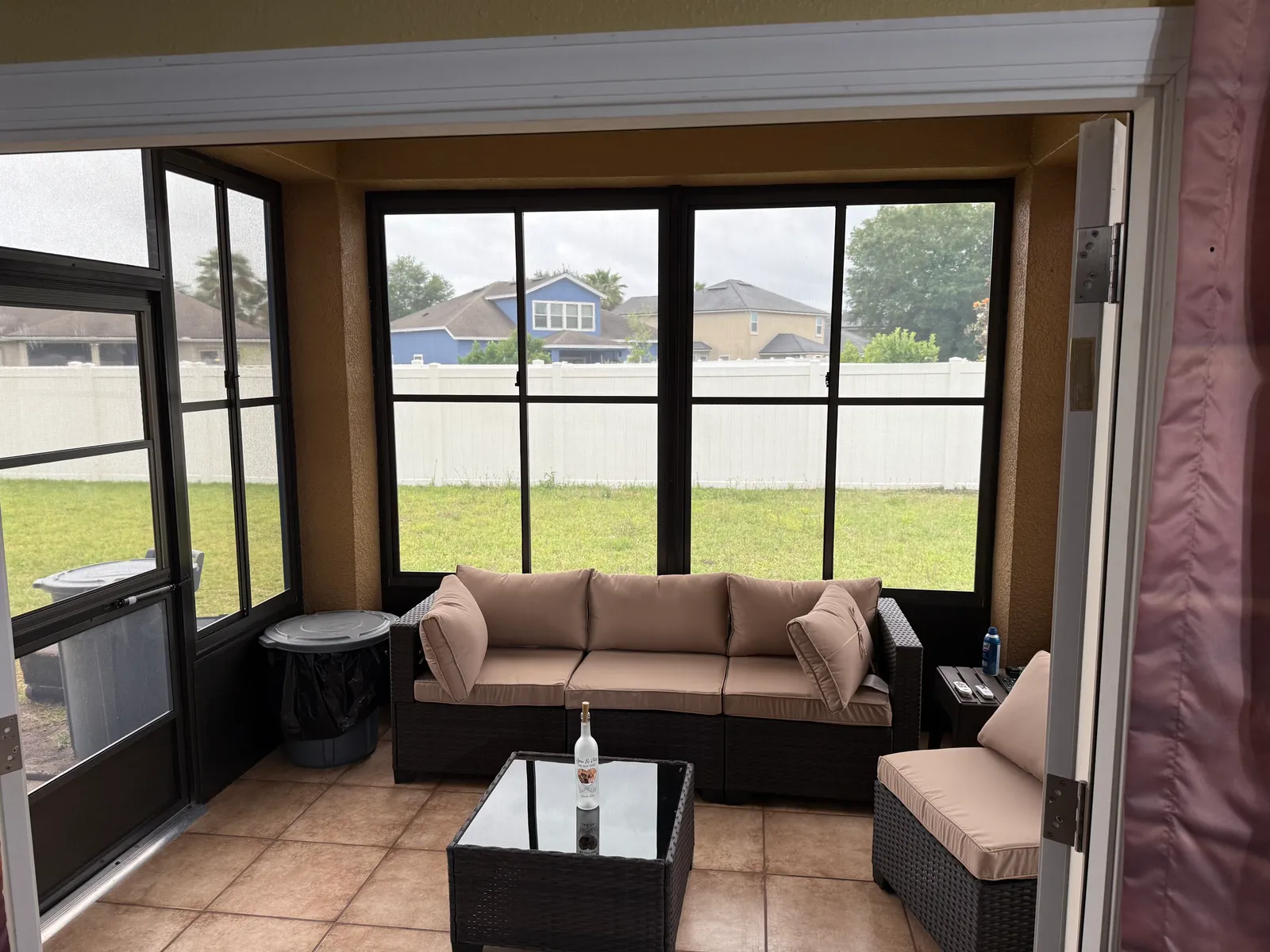Interior of a screened lanai with tile flooring and patio furniture, Northeast Florida